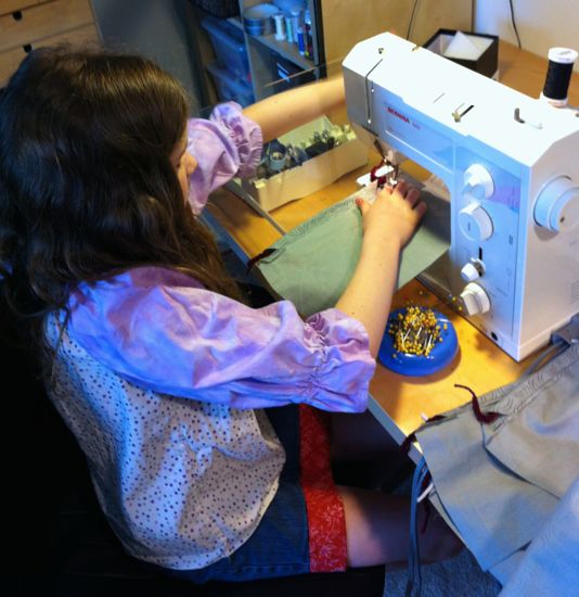 Caitlyn sews.