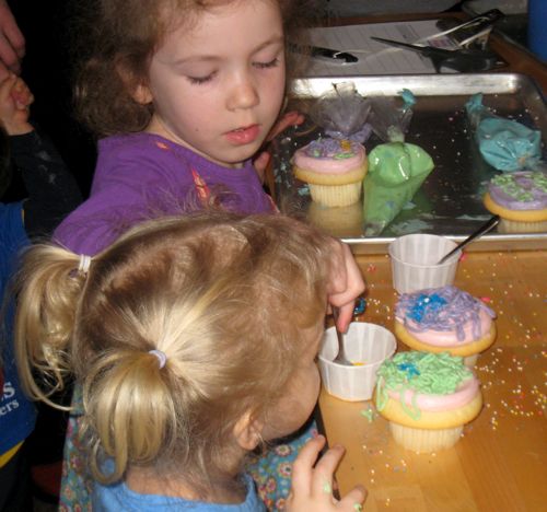 Caitlyn and Raina decorating cupcakes